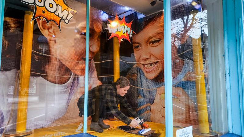 Setting up Window display for March Mannequins