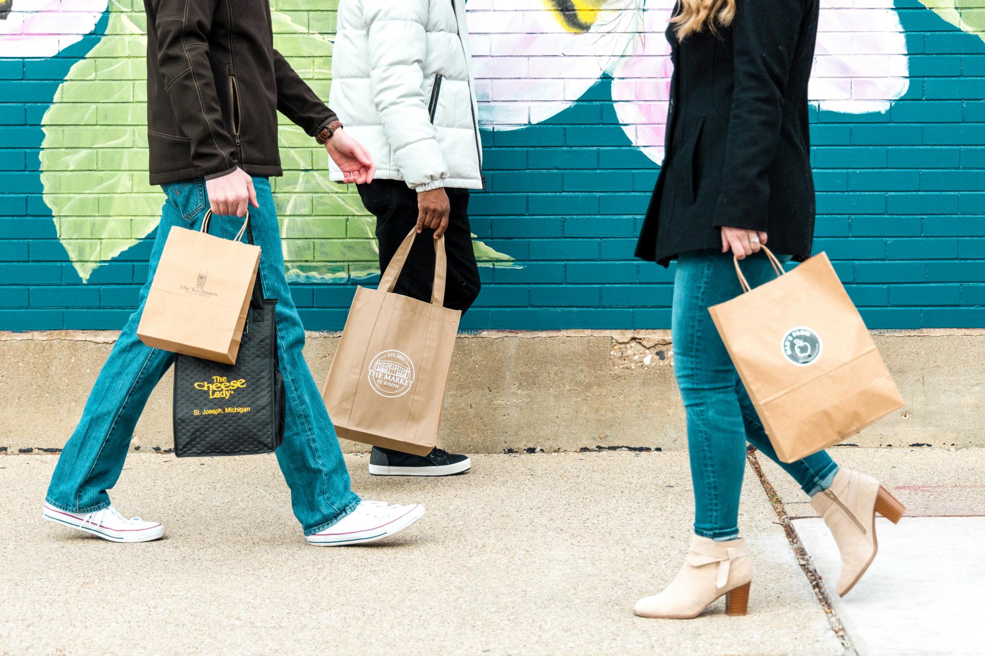 shoppers holding bags for shops at the Market, Southwest Michigan