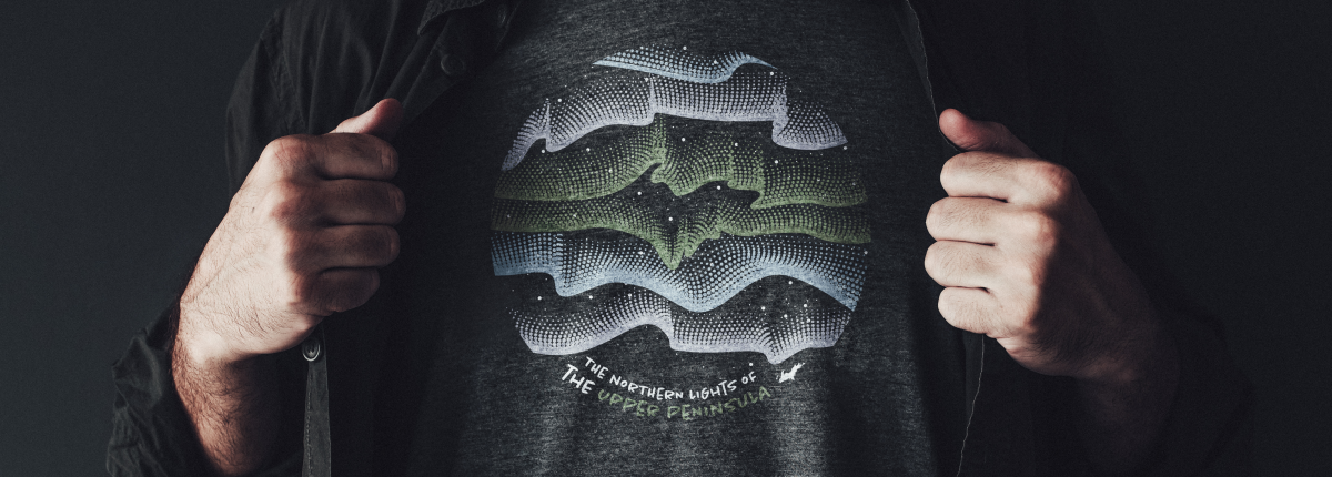 T-shirt with Northern Lights graphic in the shape of the U.P.