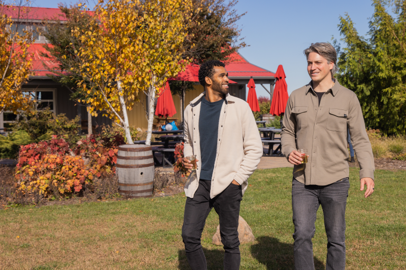 Men walking with drinks in hand
