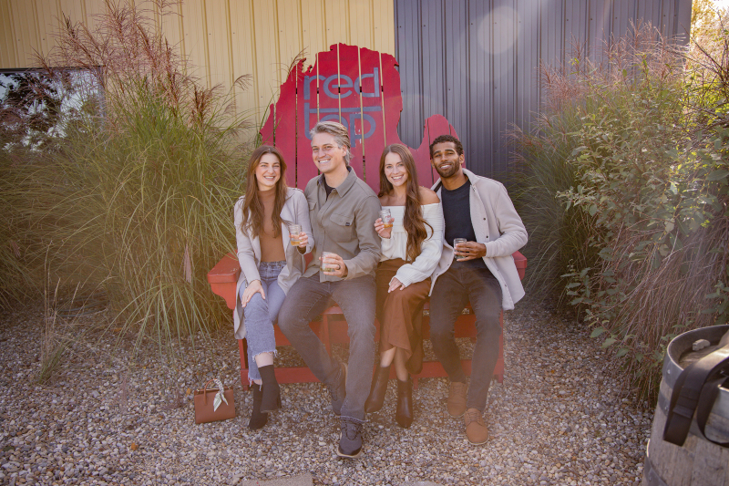 Group of people smiling for camera in giant red chair